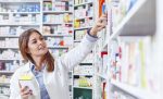 Photo of a professional pharmacist checking stock in an aisle of